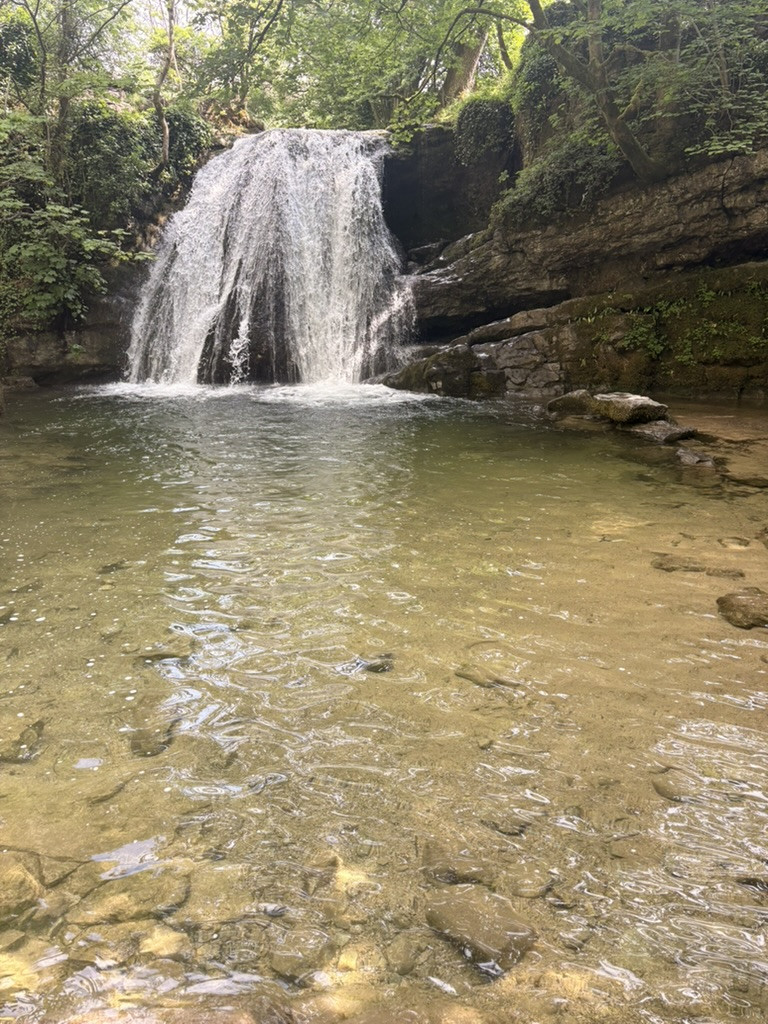 Janet's Foss cascading into a clear woodland pool on the Grassington to Malham walk