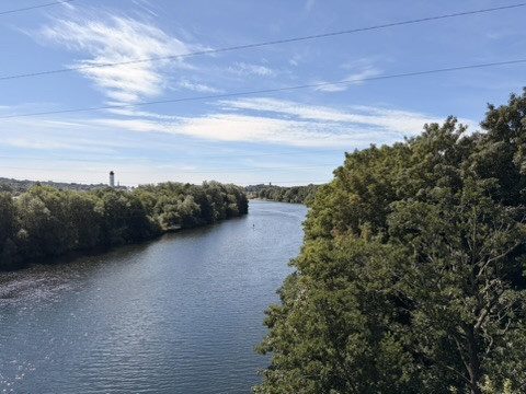 Wide view along the River Lune from the canal bridge crossing above the wooded riverbanks