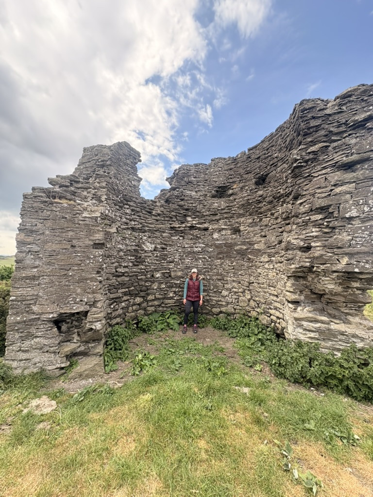 Veronica standing inside the weathered stone walls of the old lookout tower.